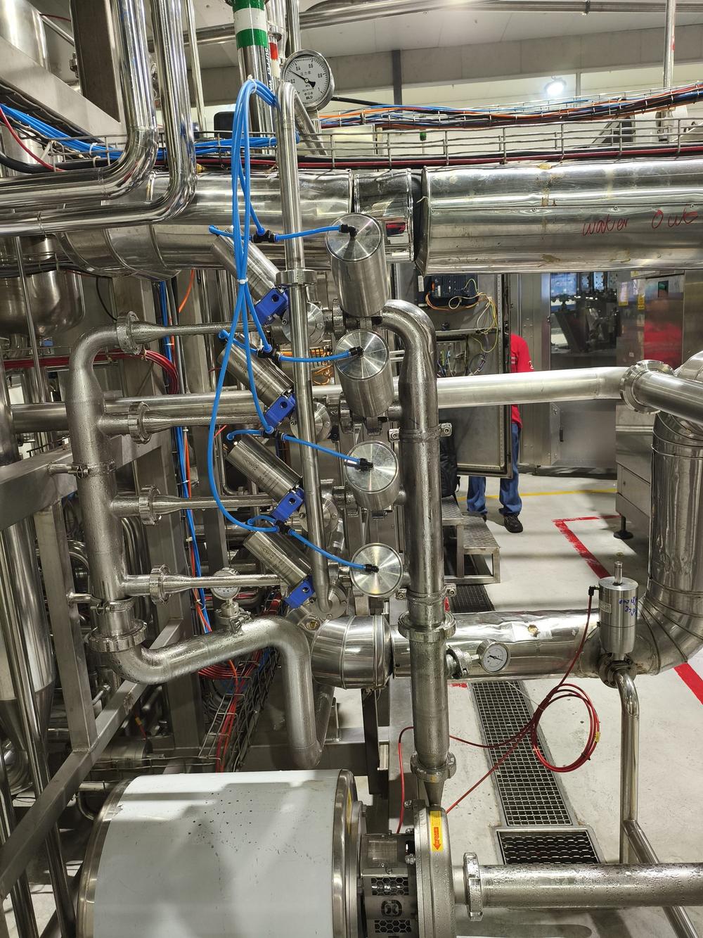 Sanitary stainless-steel carbonation system modules installed on a Coca-Cola beverage filling line.