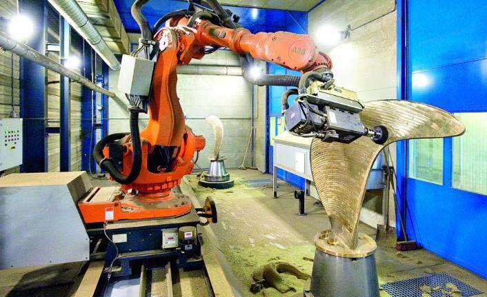 Industrial robot machining a large component.
